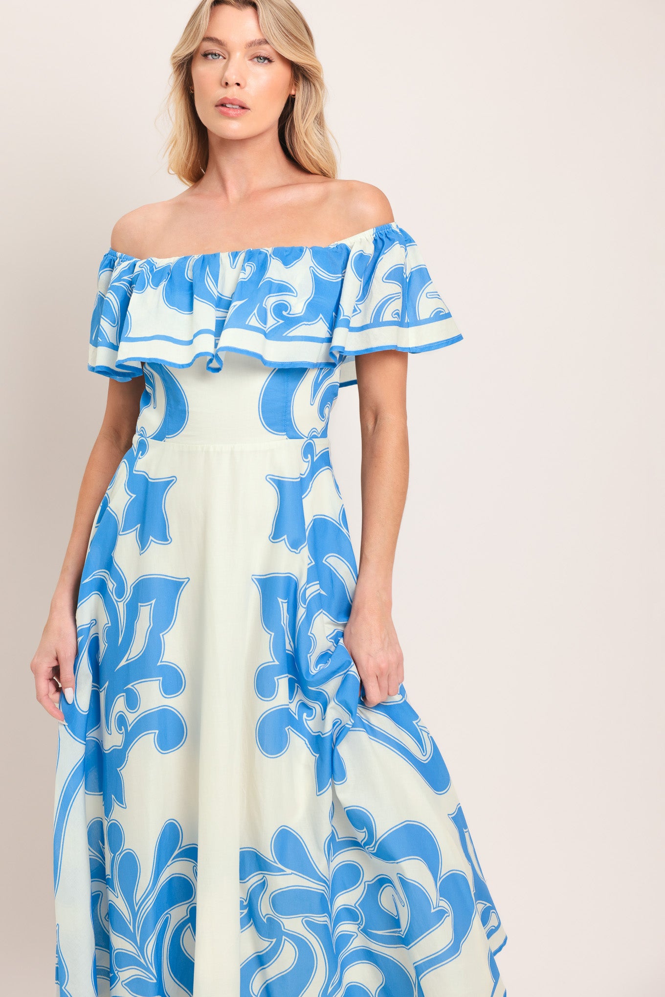 Woman wearing a blue and white patterned off the shoulder midi dress | Flying Tomato