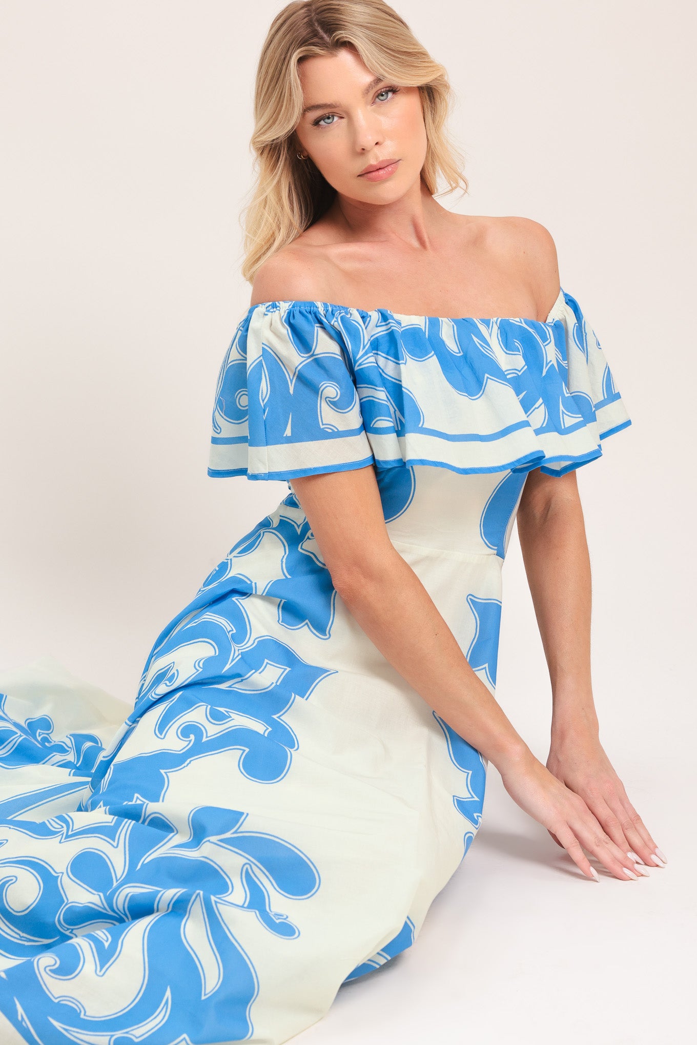 Woman wearing a blue and white patterned off the shoulder midi dress | Flying Tomato