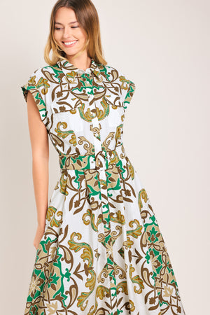 Woman wearing a green, brown, and white patterned midi shirt dress featuring cuffed short sleeve, front button down, self belt and side pockets | Flying Tomato