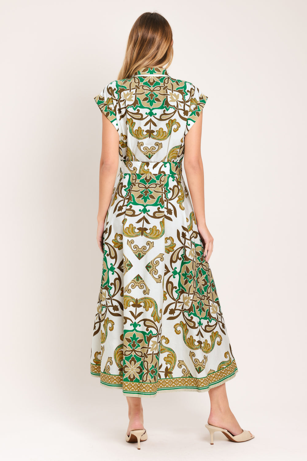 Woman wearing a green, brown, and white patterned midi shirt dress featuring cuffed short sleeve, front button down, self belt and side pockets | Flying Tomato
