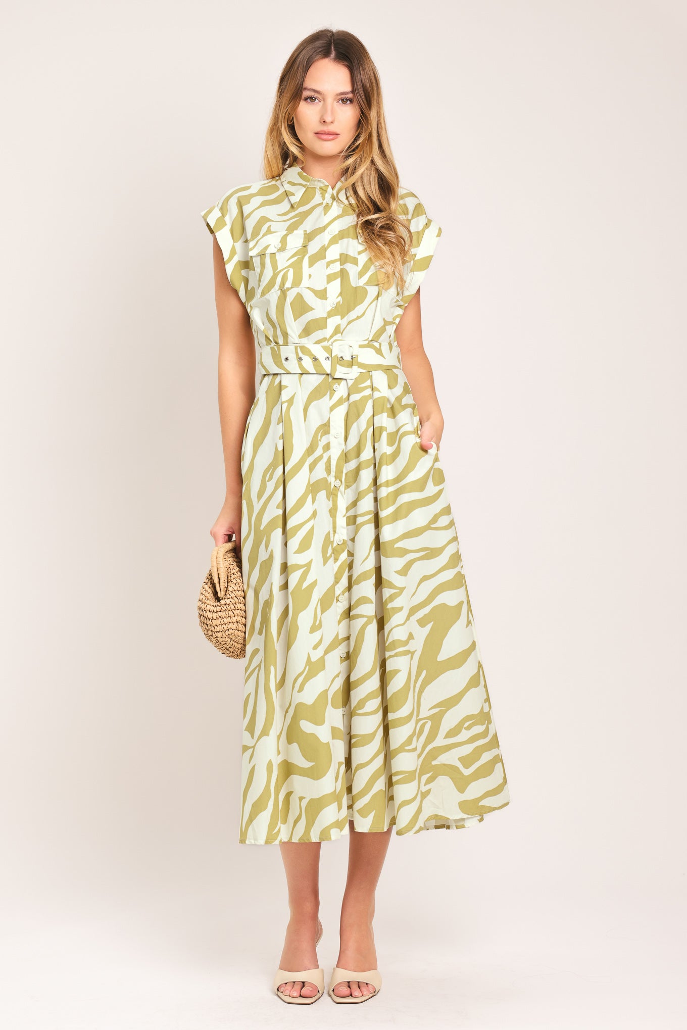 Woman wearing an ivory with taupe zebra printed midi shirt dress featuring cuffed short sleeve, front button down, self belt and side pockets | Flying Tomato