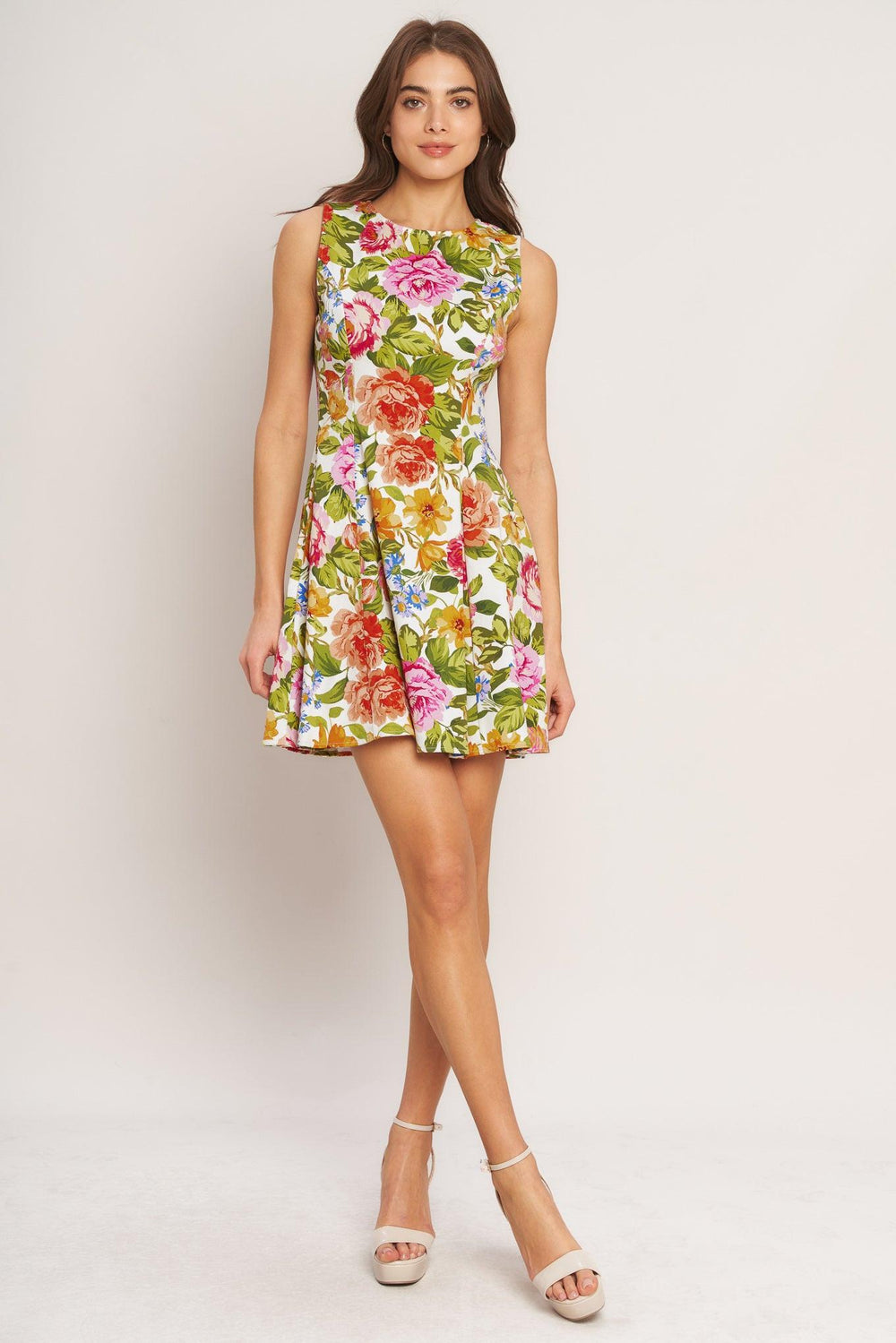 A printed woven mini dress featuring round neckline, sleeveless, circle skirt and back zipper closure