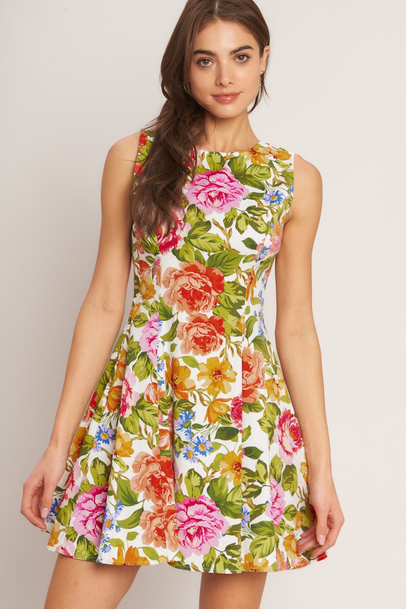 A printed woven mini dress featuring round neckline, sleeveless, circle skirt and back zipper closure