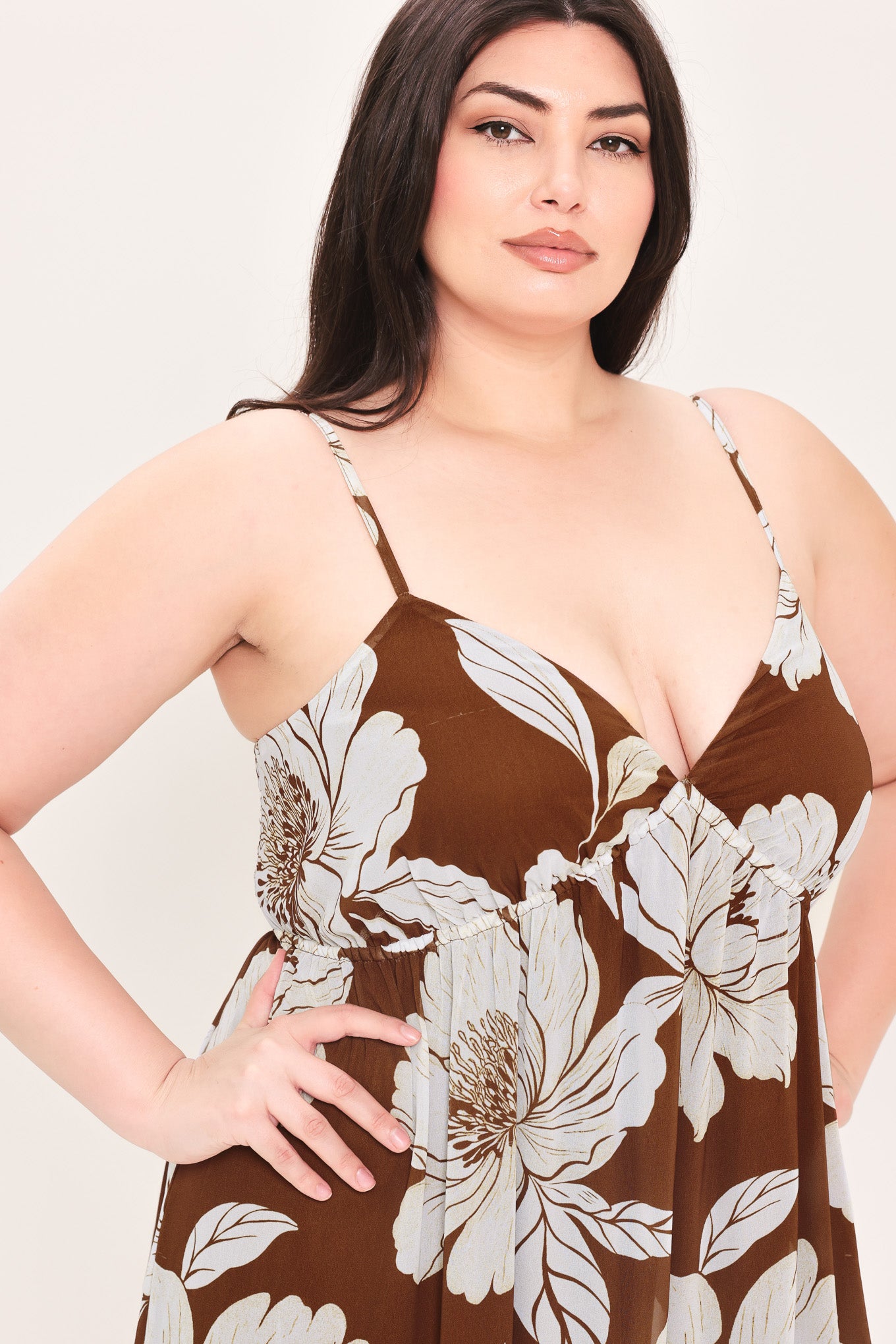Woman wearing a brown with beige flowers maxi dress with single tier and smocked back bodice | Flying Tomato