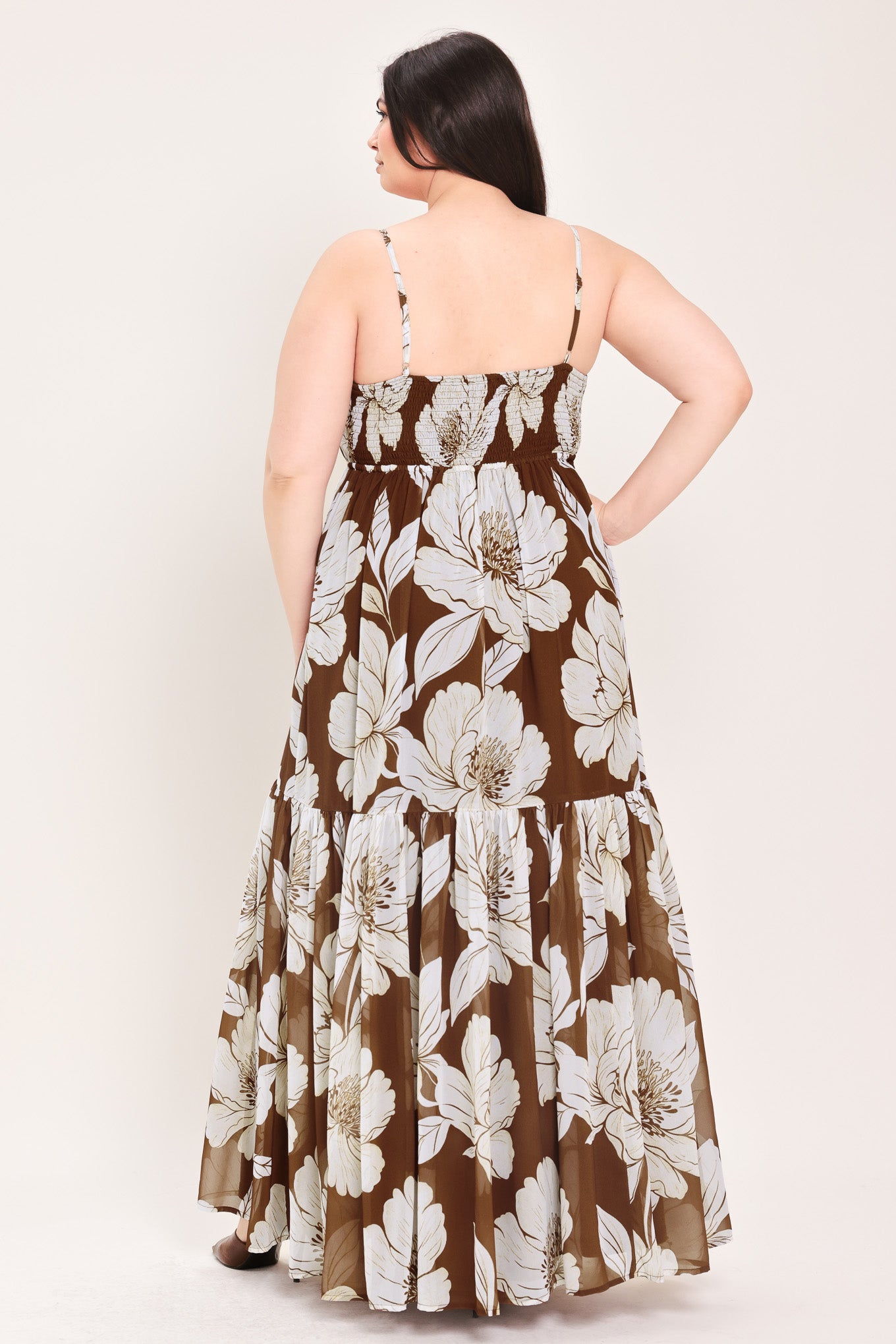 Woman wearing a brown with beige flowers maxi dress with single tier and smocked back bodice | Flying Tomato