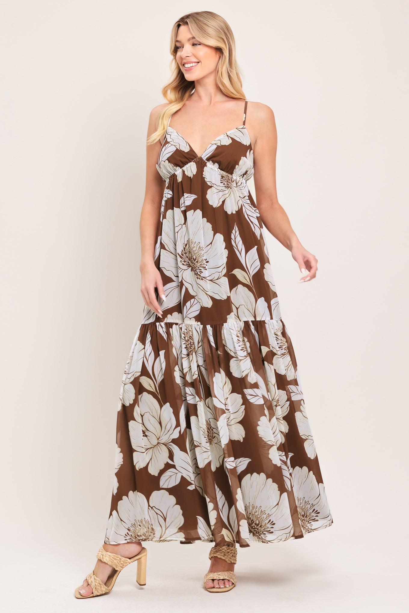Woman wearing a brown with beige flowers maxi dress with single tier and smocked back bodice | Flying Tomato