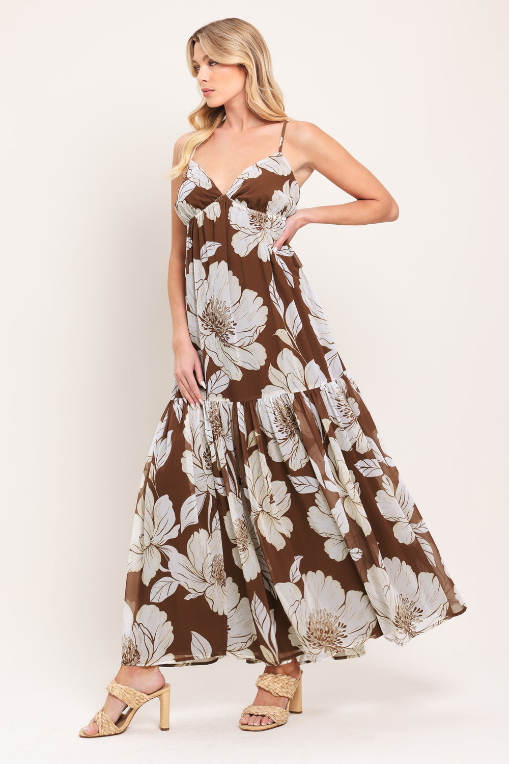 Woman wearing a brown with beige flowers maxi dress with single tier and smocked back bodice | Flying Tomato