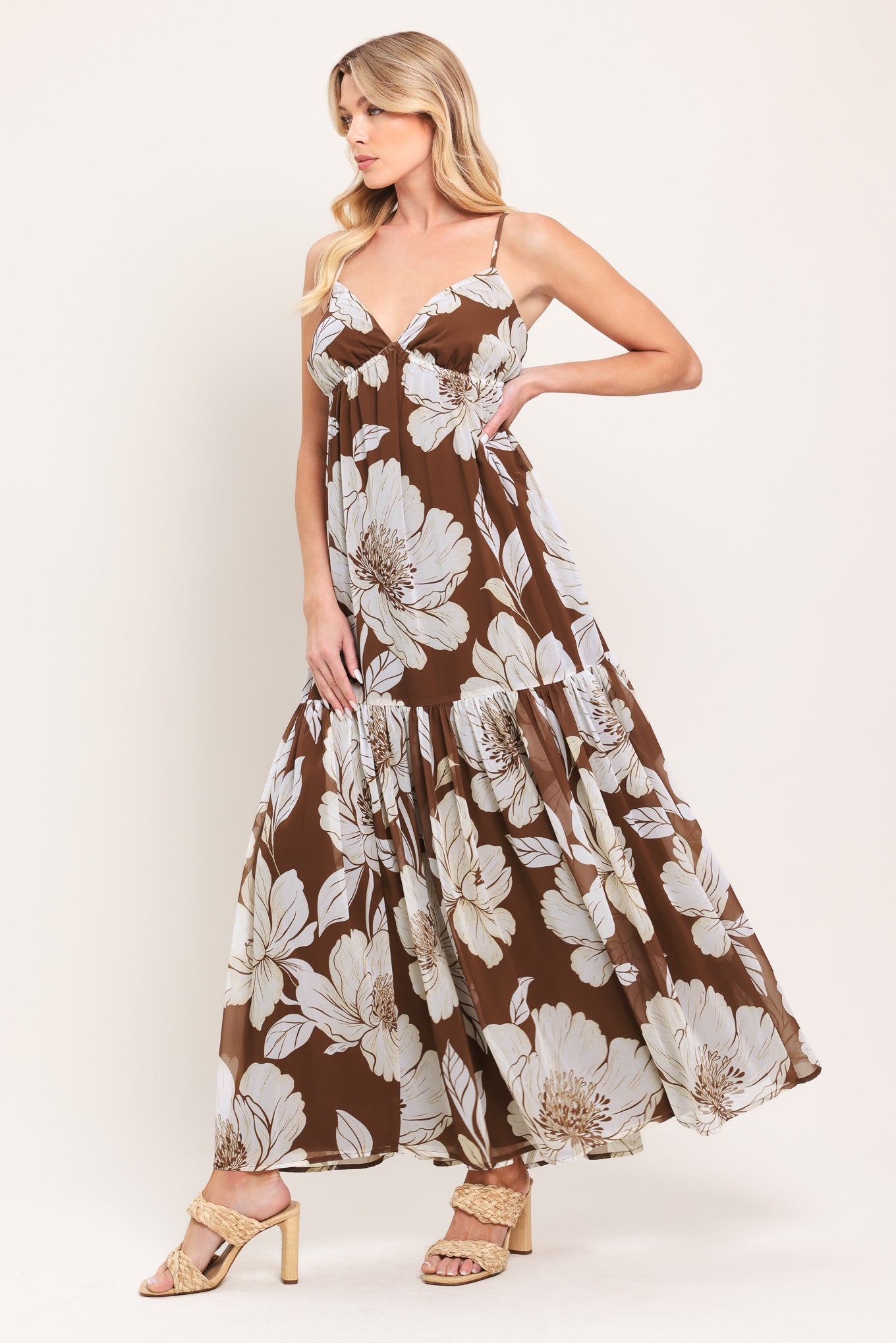 Woman wearing a brown with beige flowers maxi dress with single tier and smocked back bodice | Flying Tomato