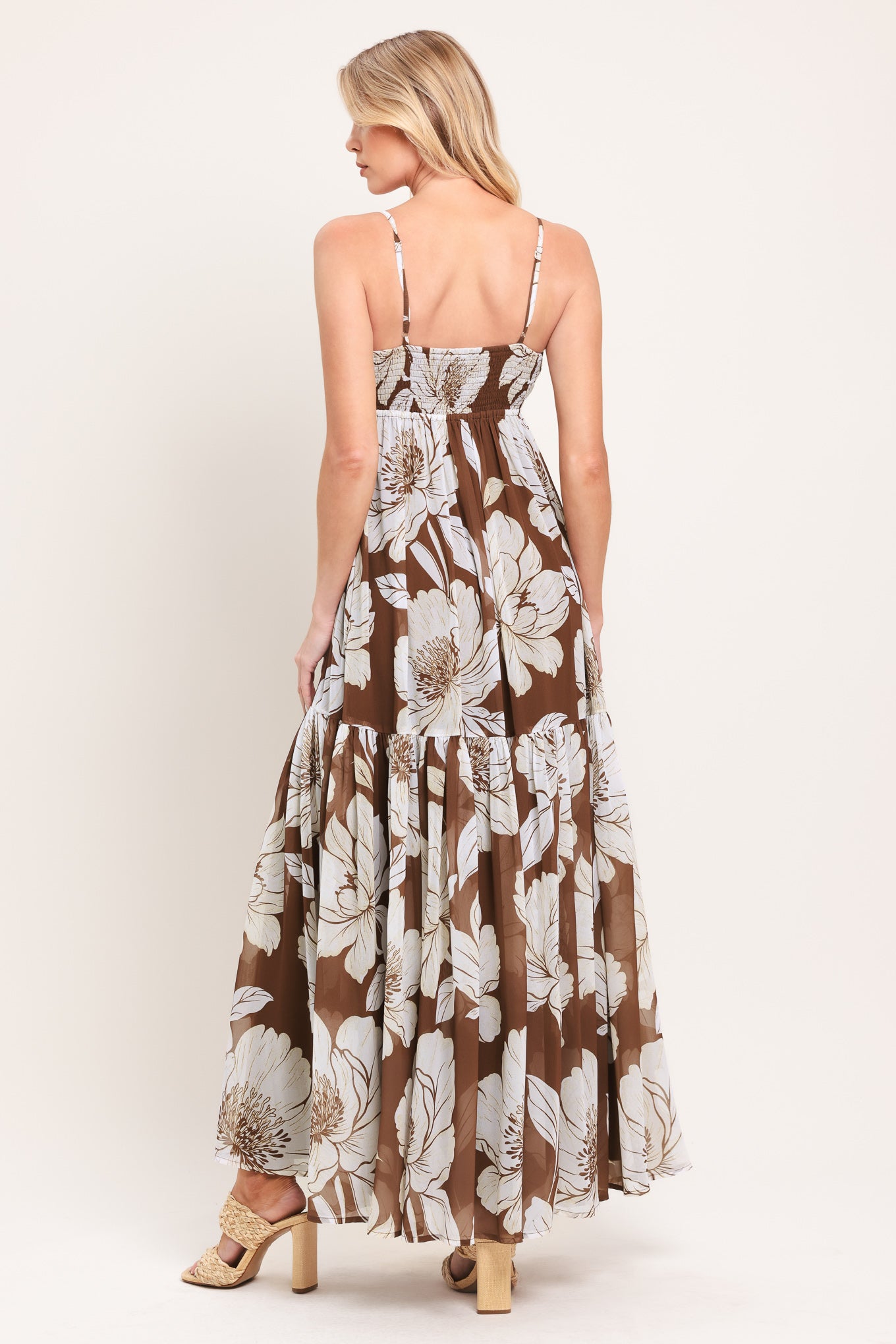 Woman wearing a brown with beige flowers maxi dress with single tier and smocked back bodice | Flying Tomato