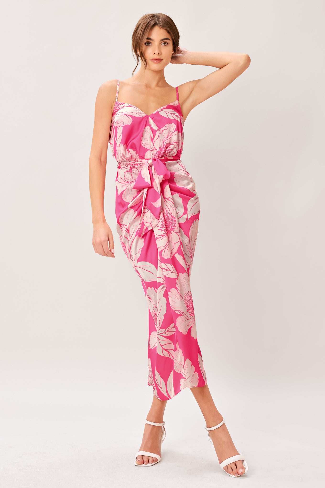 A printed woven midi dress featuring cami top, self sash, waterfall front and elastic back waist