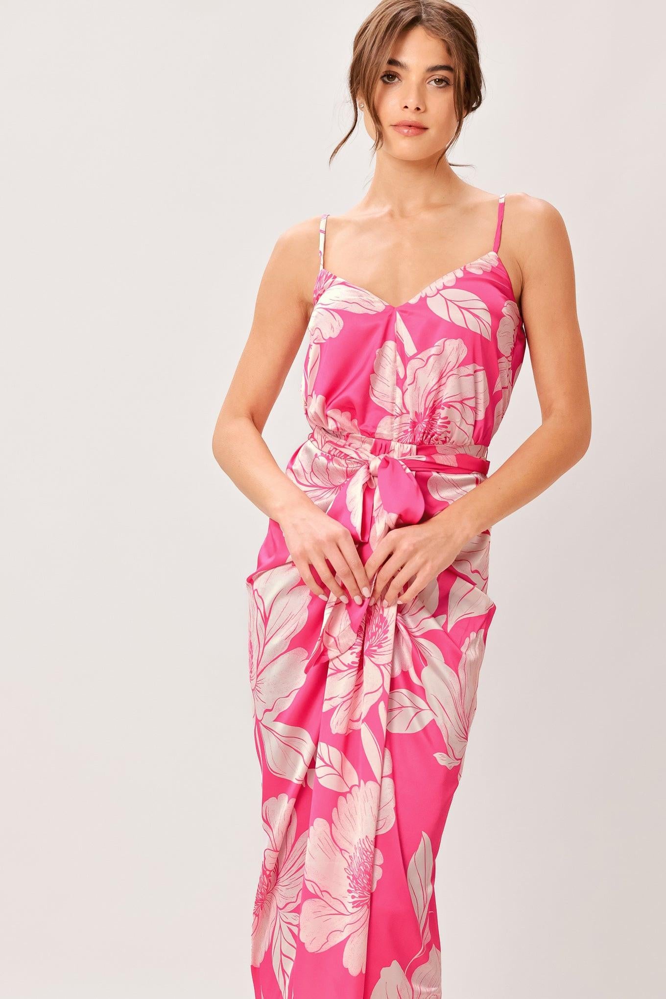 A printed woven midi dress featuring cami top, self sash, waterfall front and elastic back waist