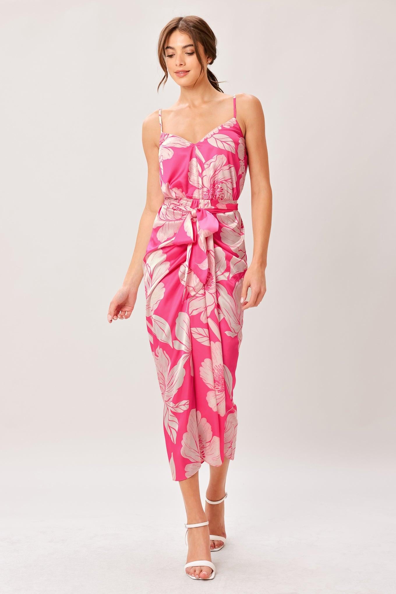 A printed woven midi dress featuring cami top, self sash, waterfall front and elastic back waist