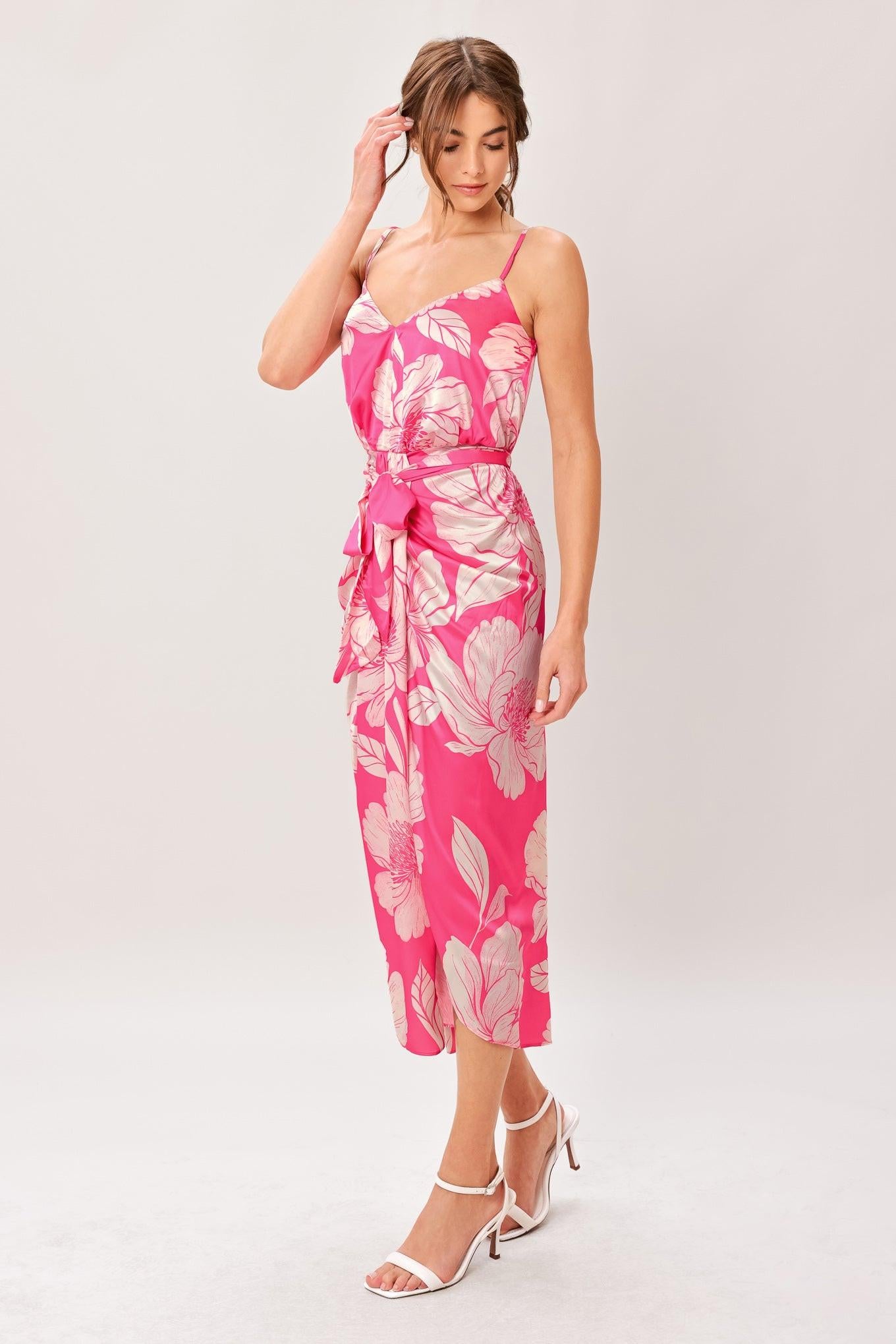 A printed woven midi dress featuring cami top, self sash, waterfall front and elastic back waist