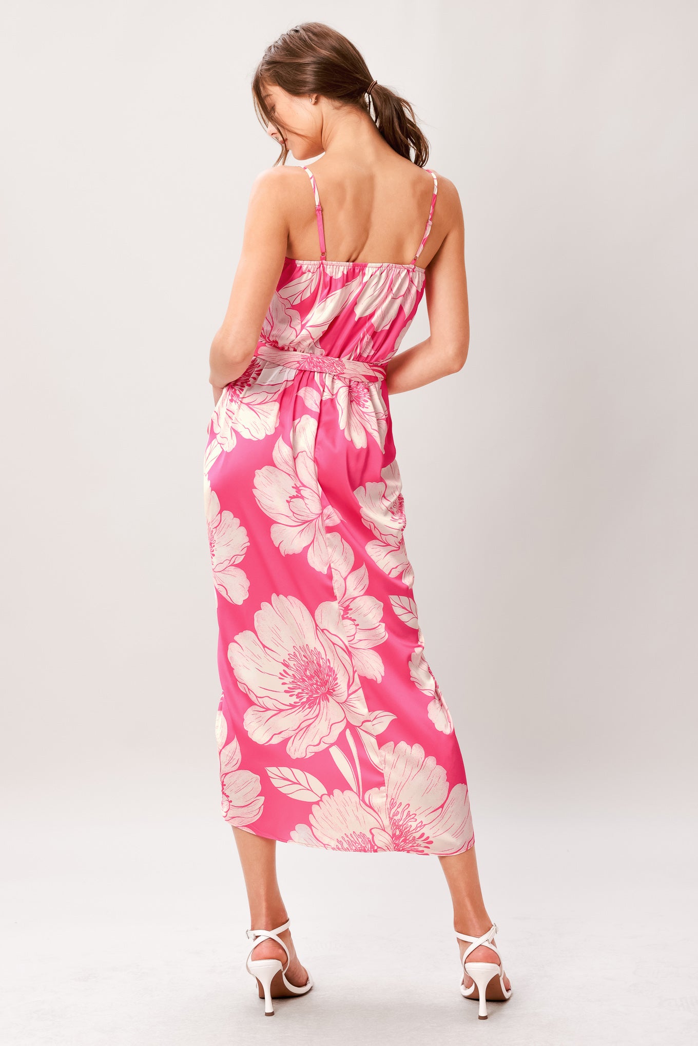 A printed woven midi dress featuring cami top, self sash, waterfall front and elastic back waist