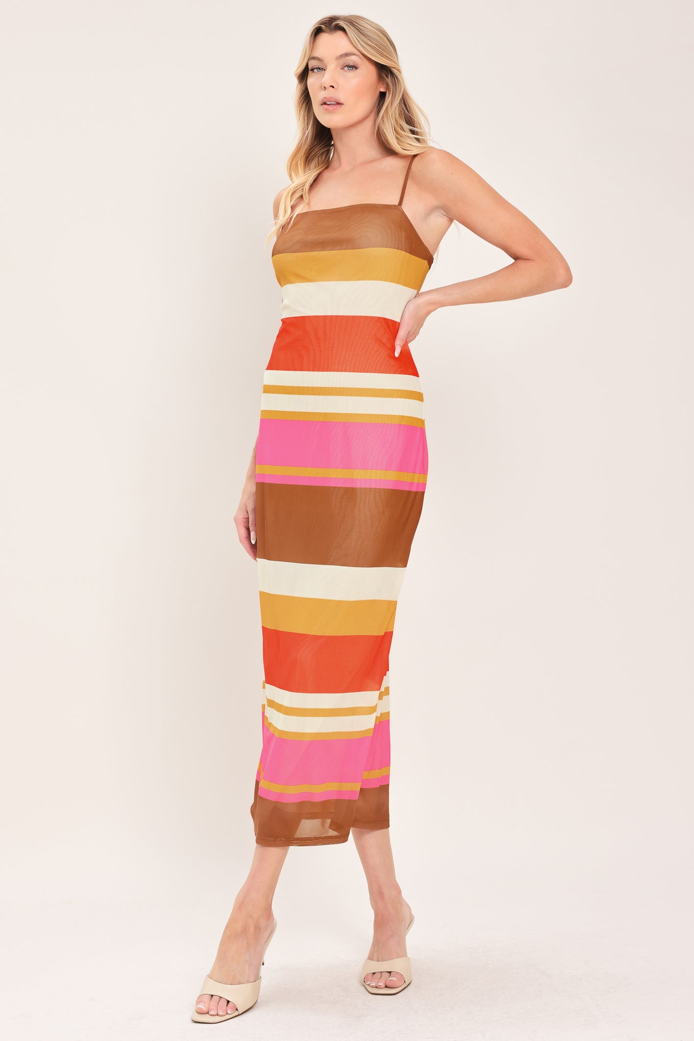 Woman wearing a colorful striped power mesh midi dress | Flying Tomato