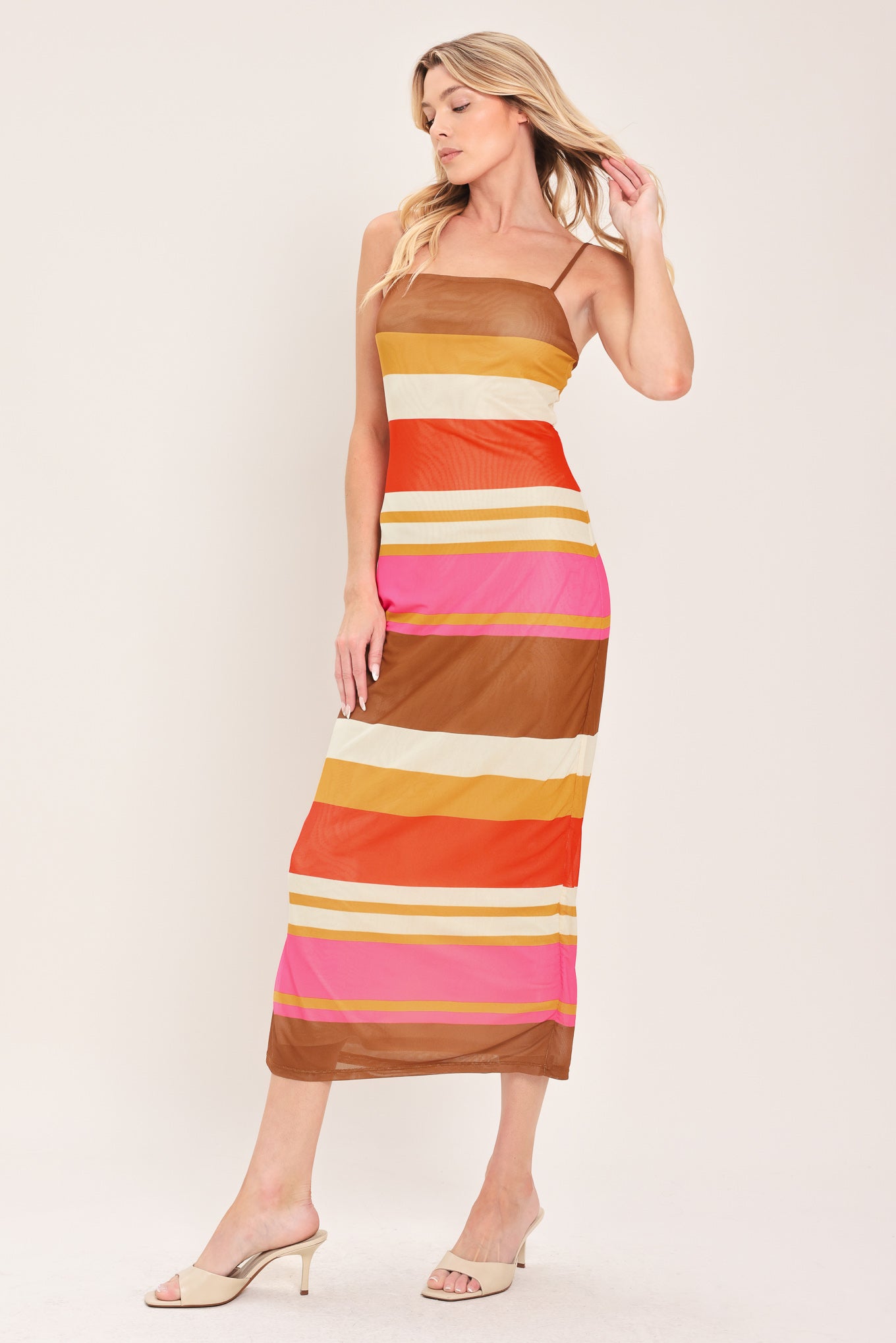 Woman wearing a colorful striped power mesh midi dress | Flying Tomato
