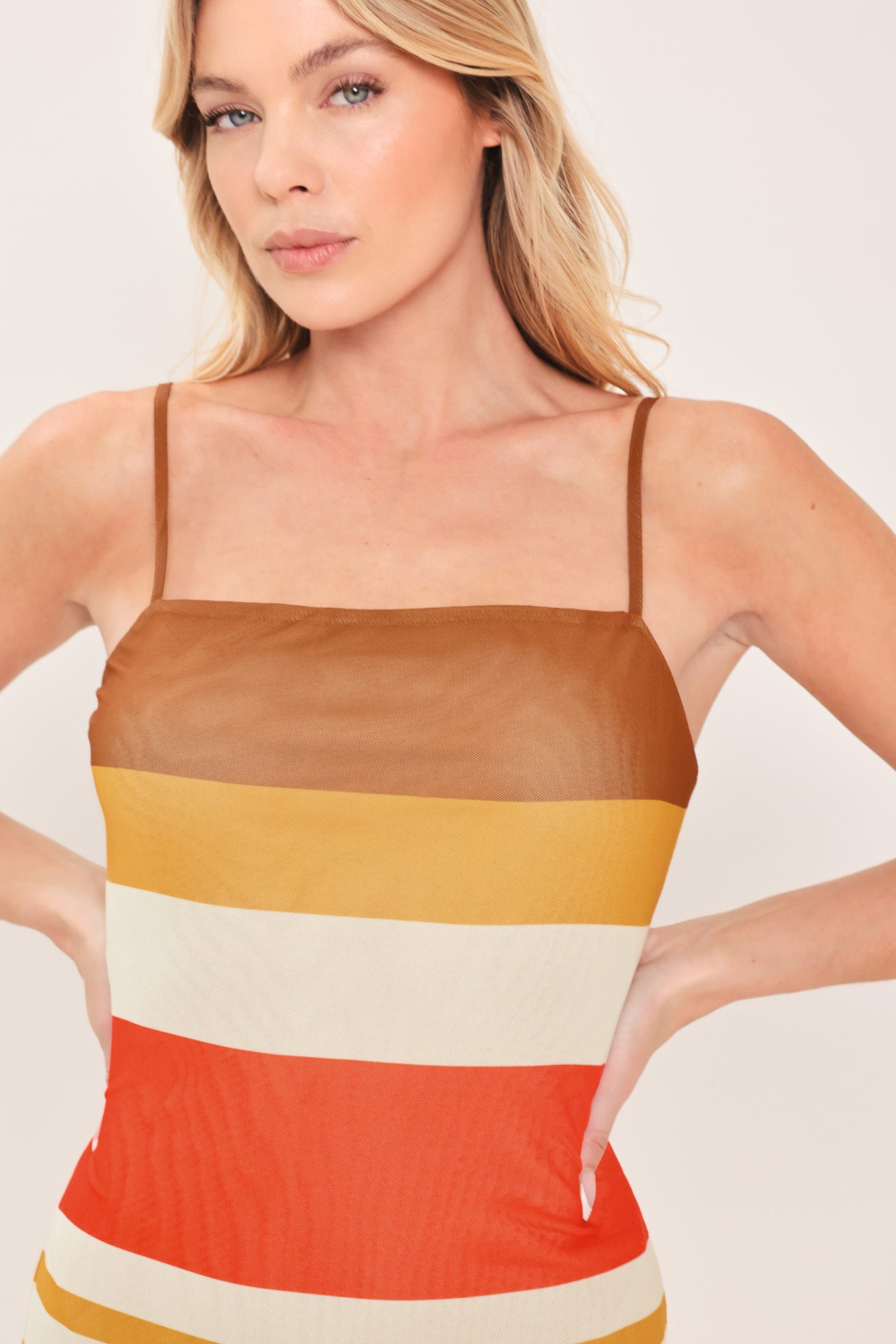 Woman wearing a colorful striped power mesh midi dress | Flying Tomato