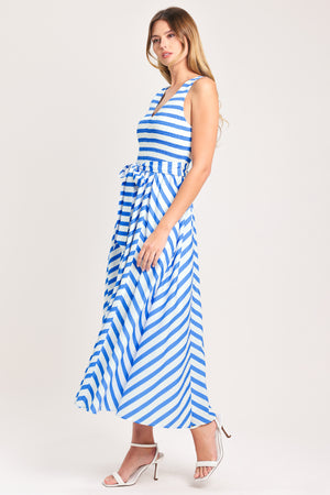 Woman wearing a blue and white striped  midi dress featuring V neckline, sleeveless, smocked bodice, self sash tie and full skirt | Flying Tomato