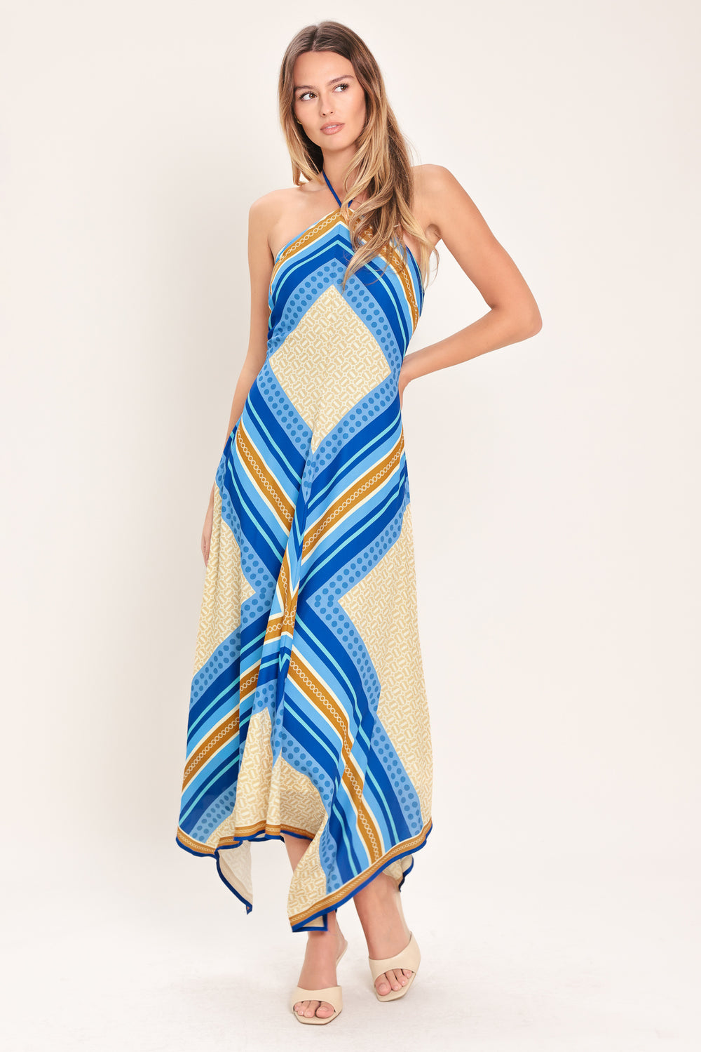Woman wearing a pink and gold midi dress featuring halter neckline with tie, hanky hem and back zipper closure | Flying Tomato