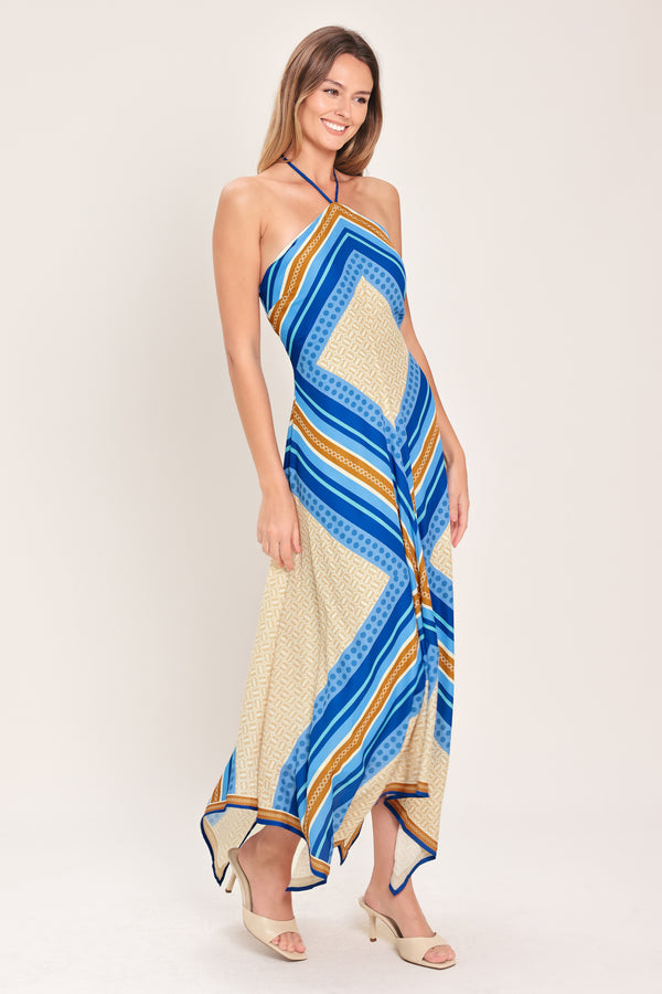 Woman wearing a blue and gold midi dress featuring halter neckline with tie, hanky hem and back zipper closure | Flying Tomato