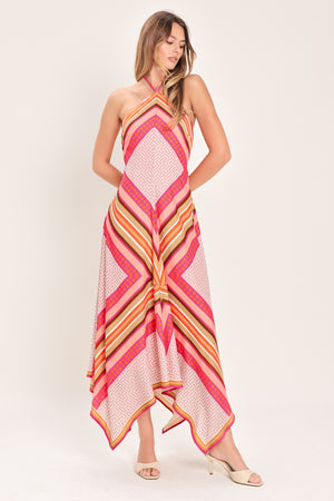 Woman wearing a pink and gold midi dress featuring halter neckline with tie, hanky hem and back zipper closure | Flying Tomato