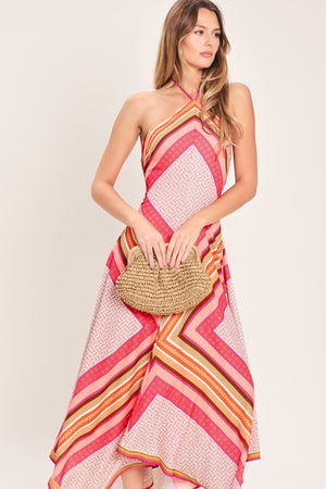 Woman wearing a pink and gold midi dress featuring halter neckline with tie, hanky hem and back zipper closure | Flying Tomato