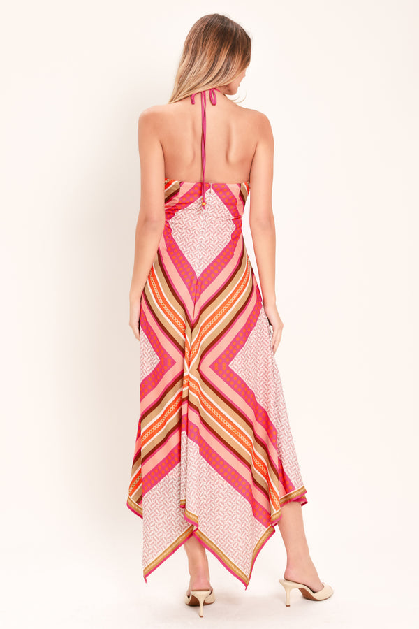 Woman wearing a pink and gold midi dress featuring halter neckline with tie, hanky hem and back zipper closure | Flying Tomato
