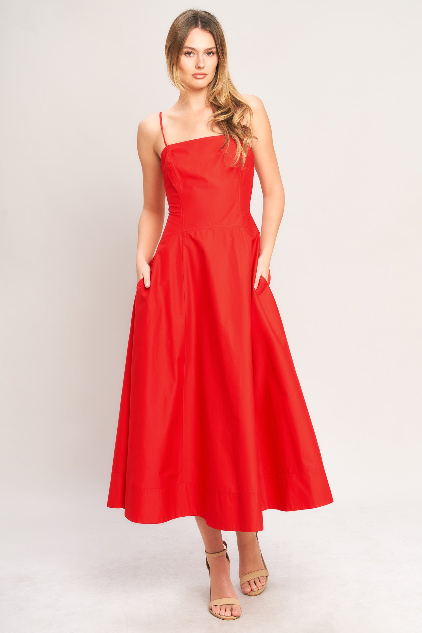 Woman wearing a red dress on a white background