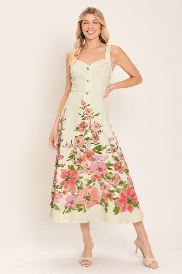 Woman wearing an ivory midi dress with pink floral pattern featuring sweetheart neckline, straps, button down detail, circle skirt and back zipper closure | Flying Tomato