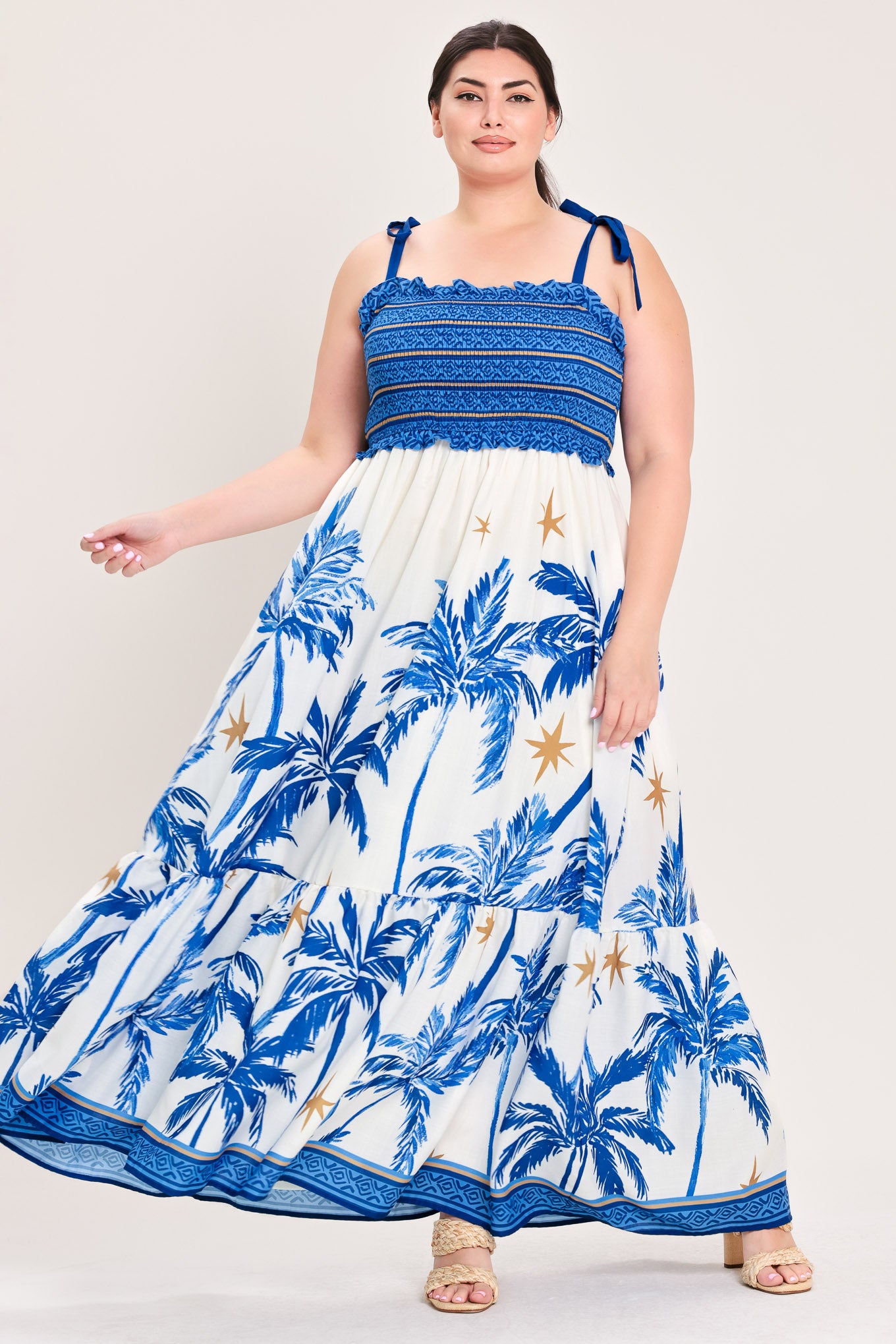 Woman wearing a blue and white dress with palm tree pattern | Flying Tomato Curve