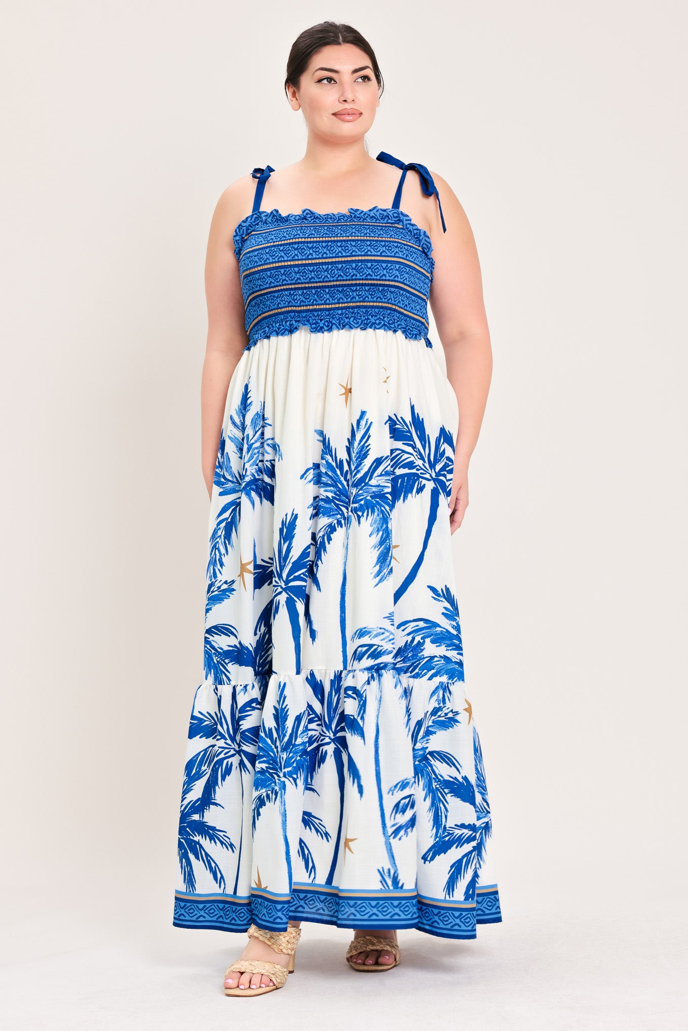 Woman wearing a blue and white dress with palm tree pattern | Flying Tomato Curve