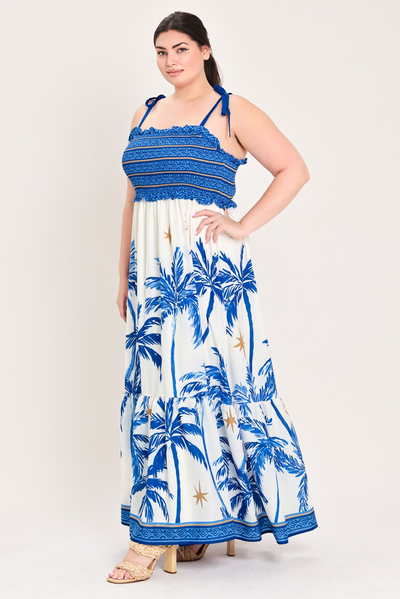 Woman wearing a blue and white dress with palm tree pattern | Flying Tomato Curve