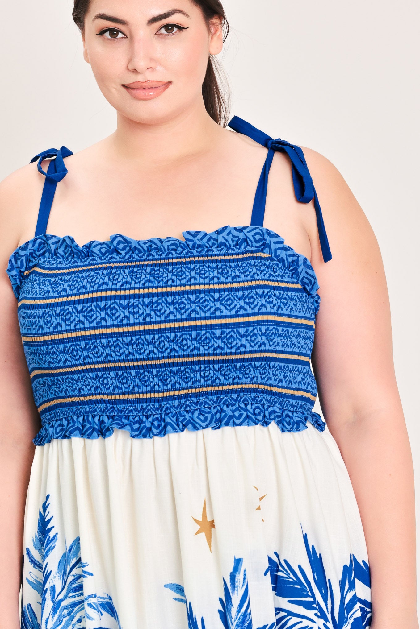 Woman wearing a blue and white dress with palm tree pattern | Flying Tomato Curve