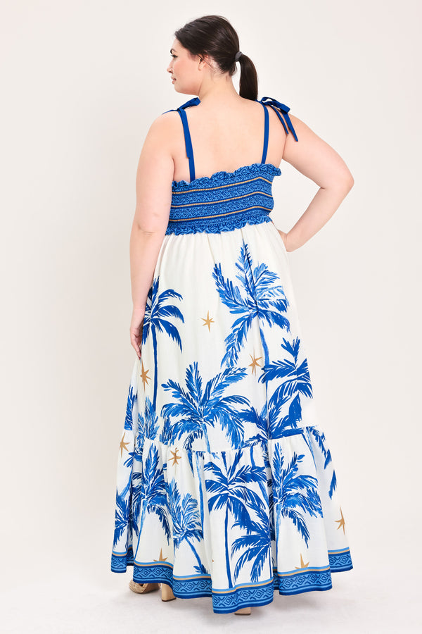 Woman wearing a blue and white dress with palm tree pattern | Flying Tomato Curve