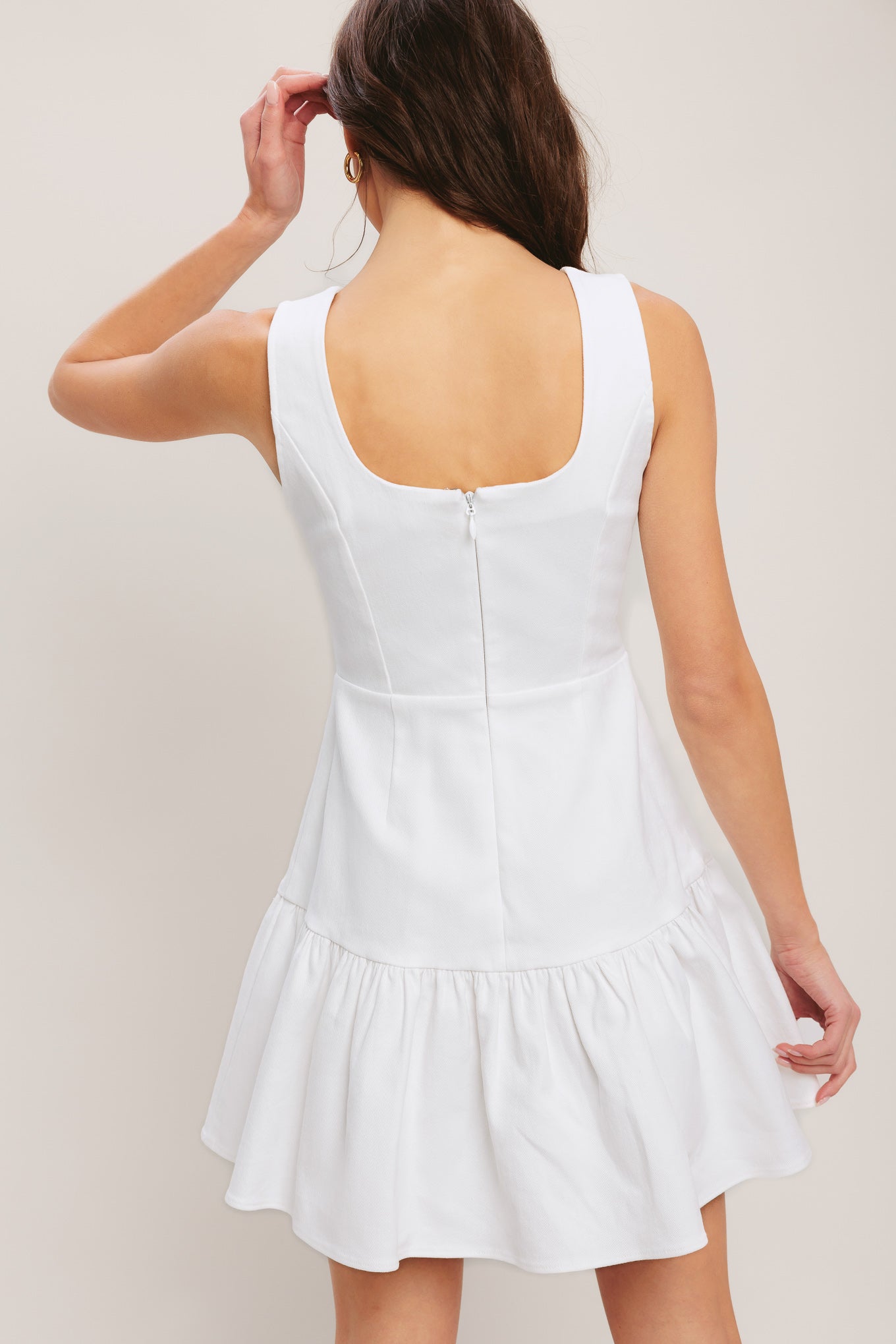 White dress worn by a person on a plain background