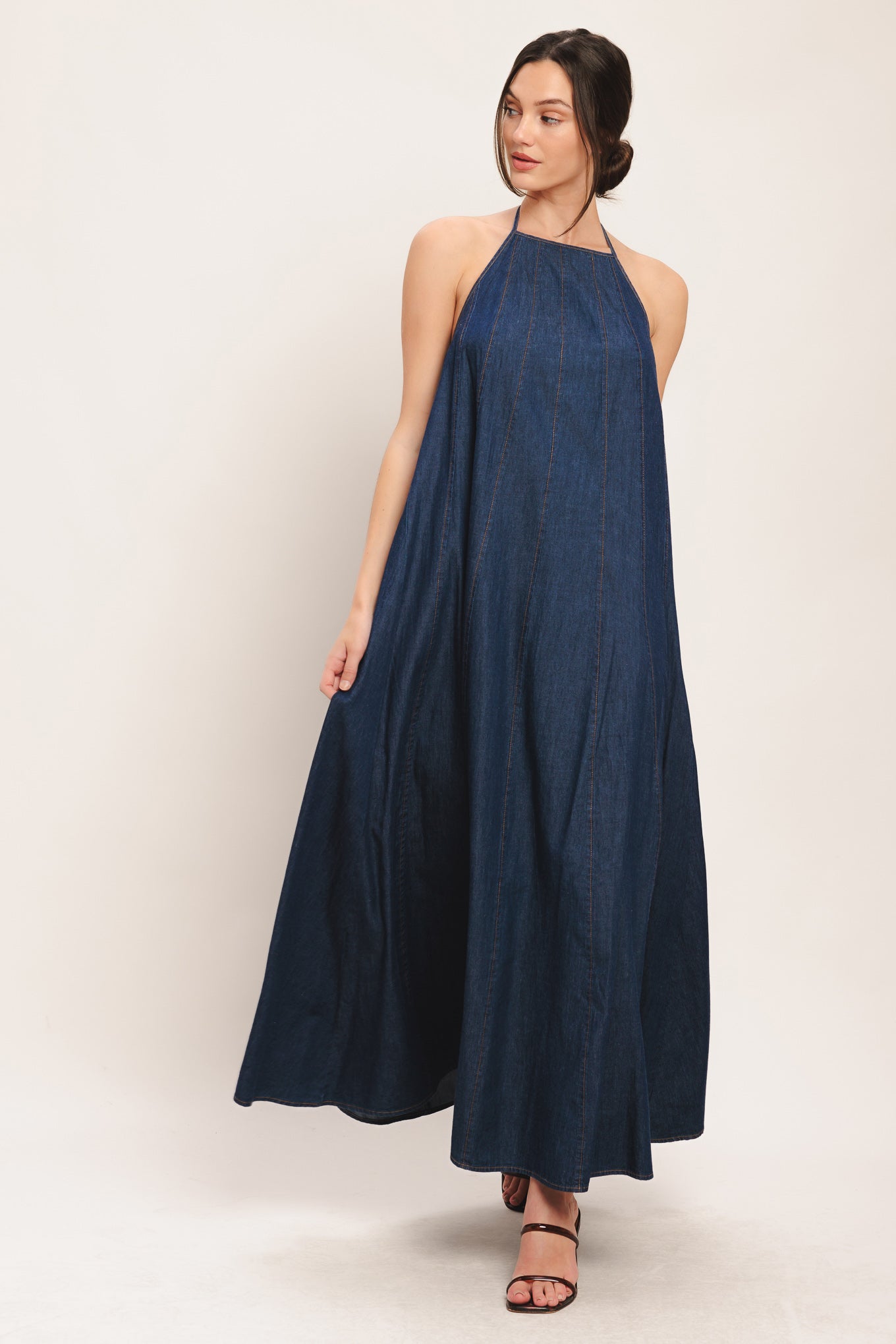 A solid denim midi dress featuring bib neckline and back neck tie and low back

Details:

Self: 100% Cotton

Size & Fit

-Model is 5`8" And Wearing Size Small
-Measurements Taken From Size Small
-Approx. Length: 53"