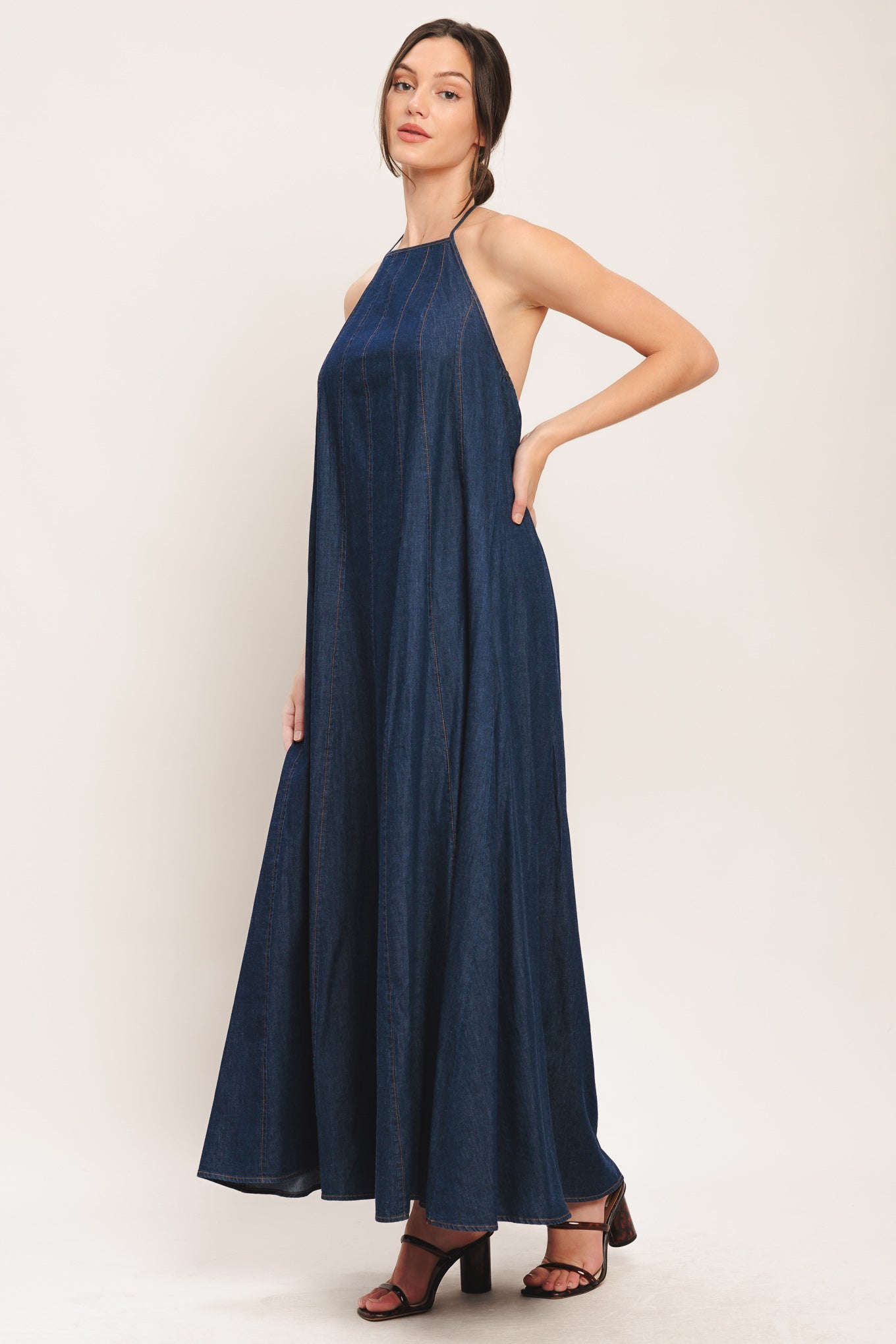 A solid denim midi dress featuring bib neckline and back neck tie and low back

Details:

Self: 100% Cotton

Size & Fit

-Model is 5`8" And Wearing Size Small
-Measurements Taken From Size Small
-Approx. Length: 53"