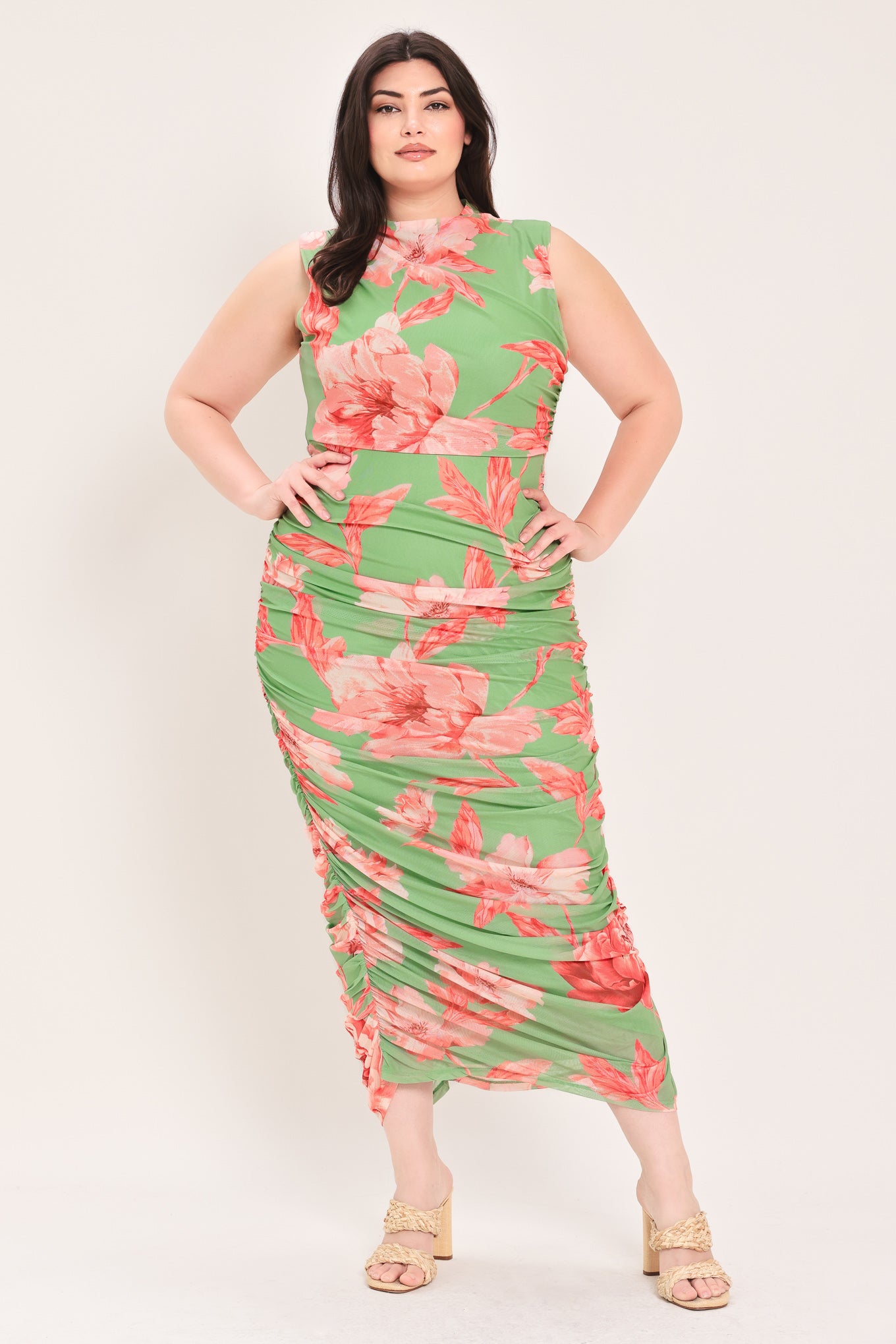 Woman wearing a sage green and pink floral printed power mesh midi dress featuring tubular neckline, sleeveless and shirred body | Flying Tomato