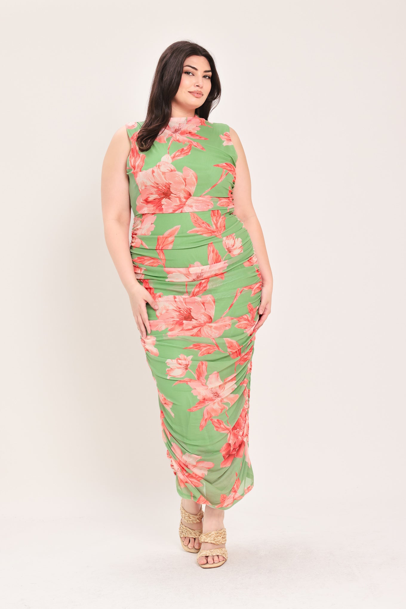 Woman wearing a sage green and pink floral printed power mesh midi dress featuring tubular neckline, sleeveless and shirred body | Flying Tomato