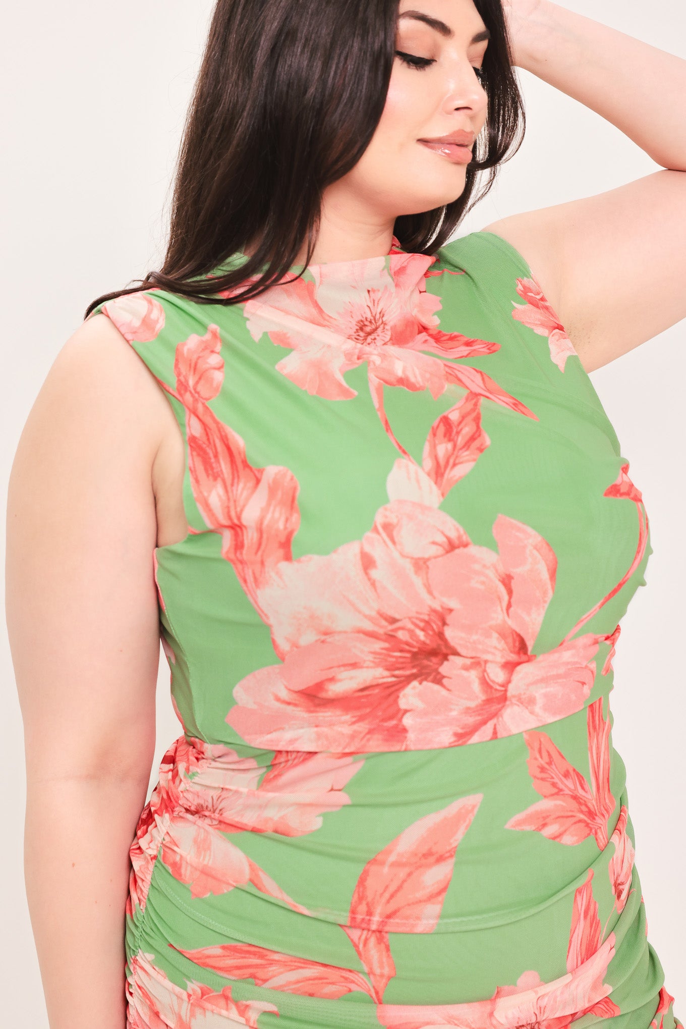 Woman wearing a sage green and pink floral printed power mesh midi dress featuring tubular neckline, sleeveless and shirred body | Flying Tomato