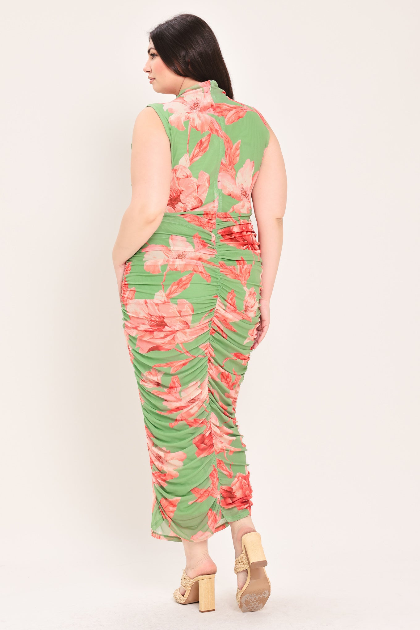Woman wearing a sage green and pink floral printed power mesh midi dress featuring tubular neckline, sleeveless and shirred body | Flying Tomato