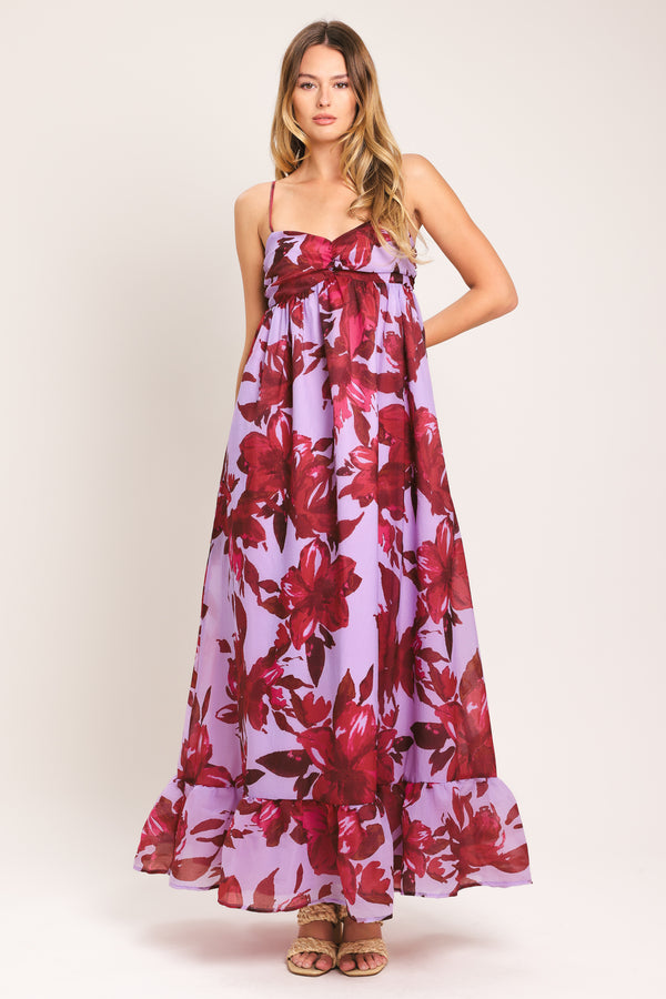 Woman wearing a lavender and berry color, floral printed woven ankle dress featuring sweetheart neckline, straps, cinched at center bust, ruffle hem and smocked back bodice | Flying Tomato