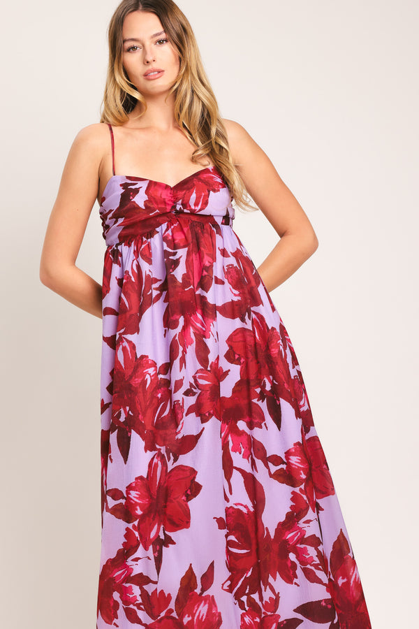 Woman wearing a lavender and berry color, floral printed woven ankle dress featuring sweetheart neckline, straps, cinched at center bust, ruffle hem and smocked back bodice | Flying Tomato