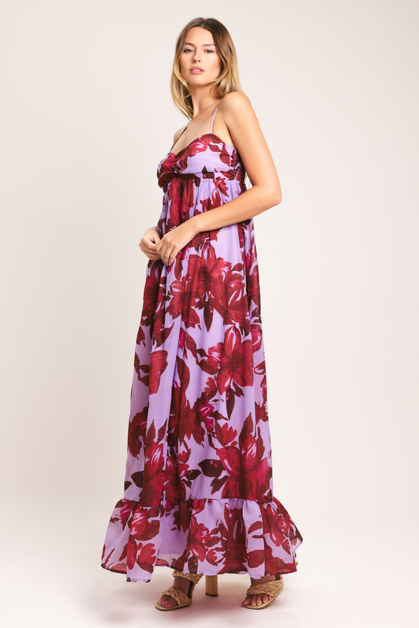 Woman wearing a lavender and berry color, floral printed woven ankle dress featuring sweetheart neckline, straps, cinched at center bust, ruffle hem and smocked back bodice | Flying Tomato