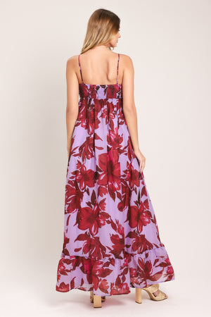 Woman wearing a lavender and berry color, floral printed woven ankle dress featuring sweetheart neckline, straps, cinched at center bust, ruffle hem and smocked back bodice | Flying Tomato