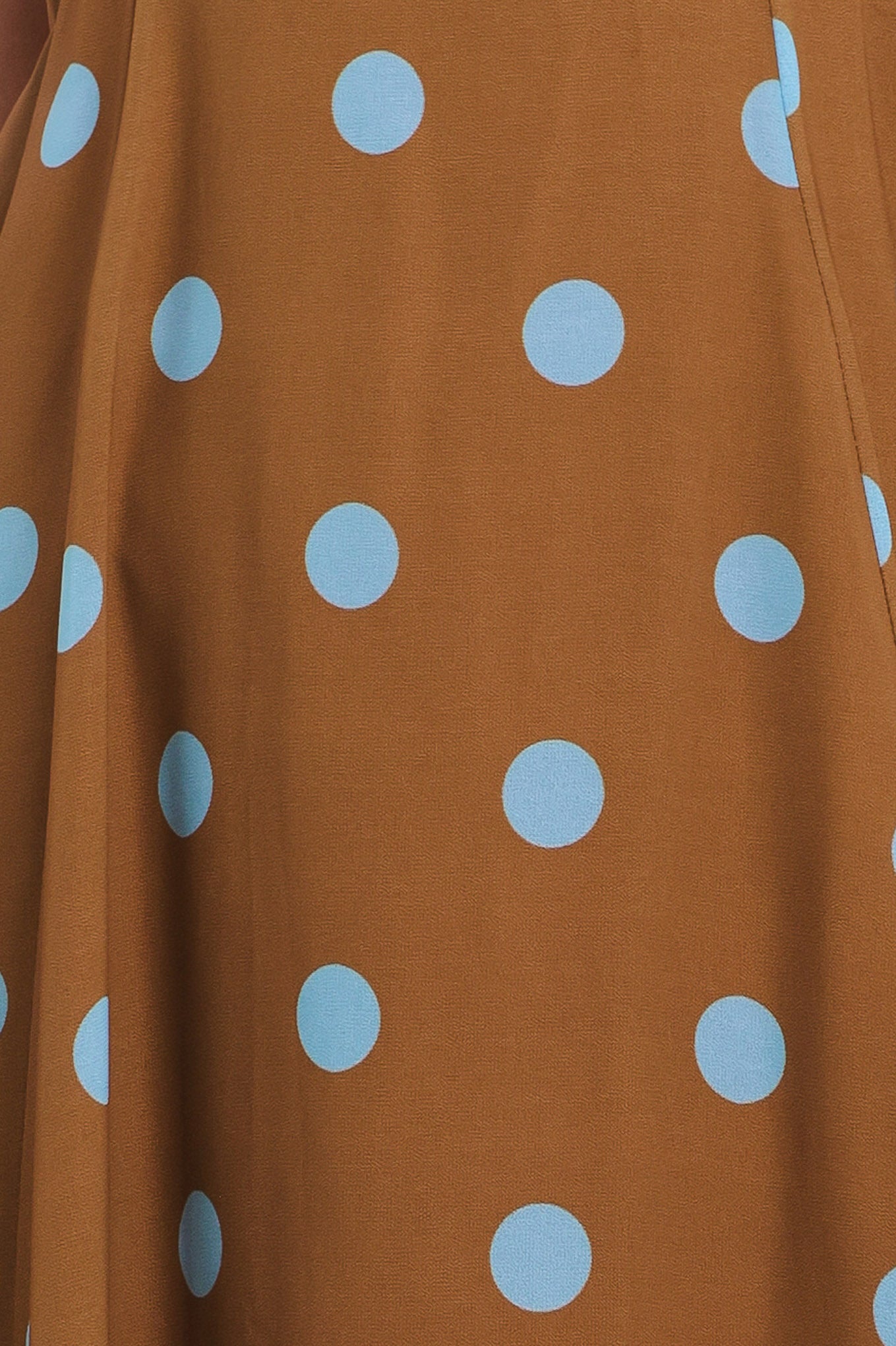 Close up of a brown with blue polka dots midi dress featuring halter neckline, circle skirt, bare back with tie neck and zipper closure | Flying Tomato