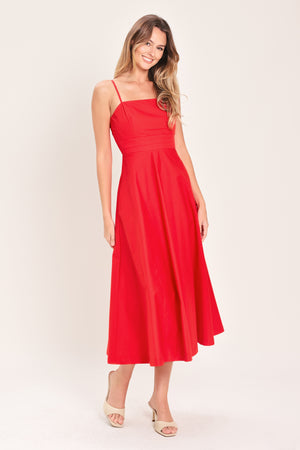 Woman wearing a red midi dress featuring straight neckline, straps, pleated waistband, circle skirt and back zipper closure | Flying Tomato