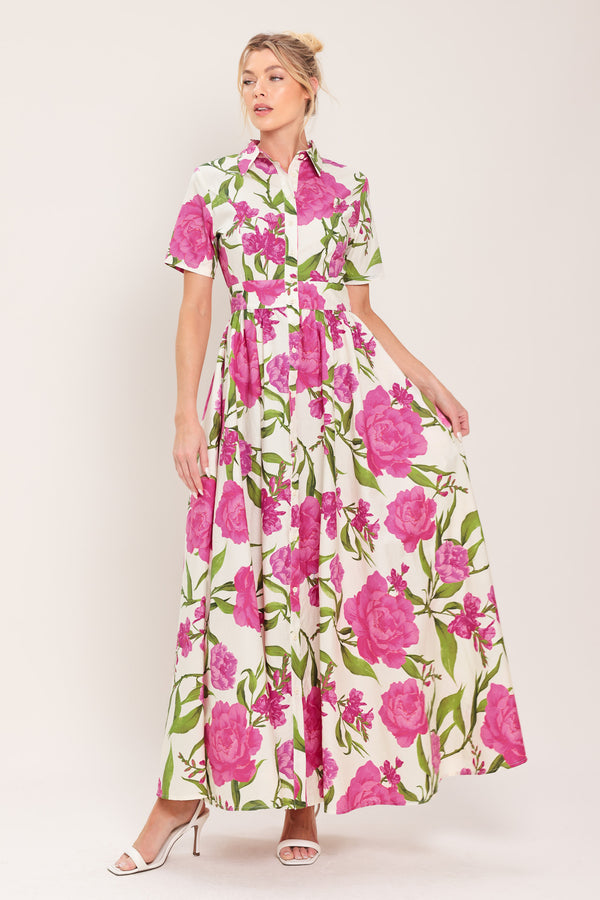 Woman wearing a short sleeve white shirt maxi dress wit pink floral print featuring front button down and full skirt | Flying Tomato