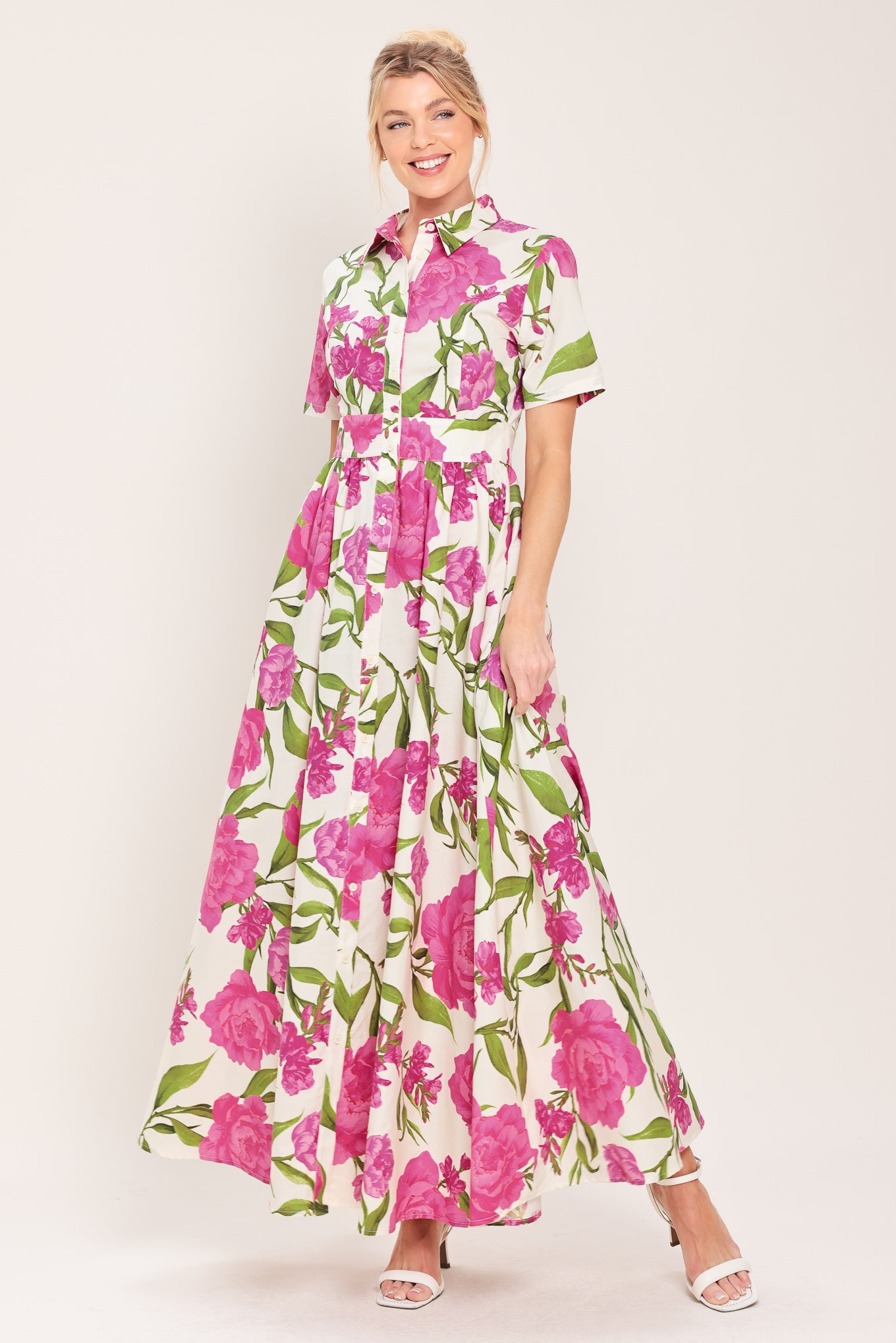 Woman wearing a short sleeve white shirt maxi dress wit pink floral print featuring front button down and full skirt | Flying Tomato
