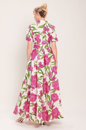 Woman wearing a short sleeve white shirt maxi dress wit pink floral print featuring front button down and full skirt | Flying Tomato